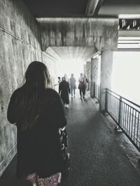 Rear view of people walking in corridor