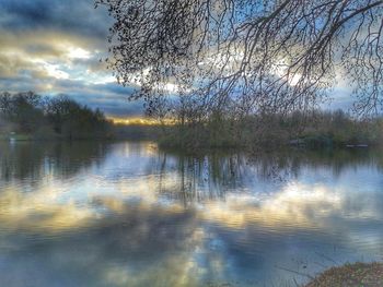 Scenic view of lake in forest against sky