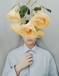 Midsection of man holding rose bouquet