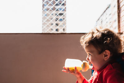 Boy holding bottle 