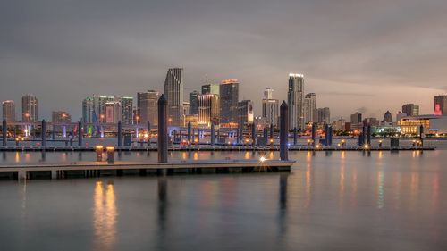 Pier over sea against buildings in city