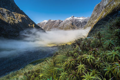 Scenic view of rock formations against blue sky