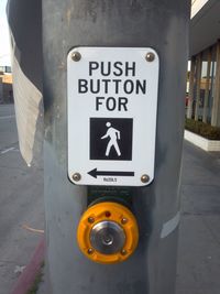 Push button with directional sign on street