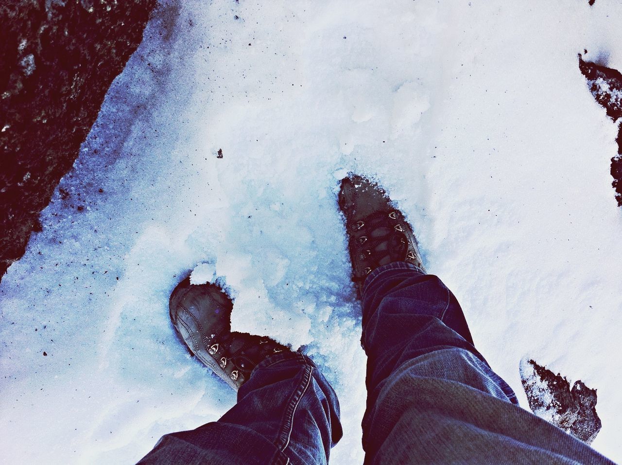 person, low section, personal perspective, lifestyles, shoe, leisure activity, standing, human foot, men, unrecognizable person, season, high angle view, water, footwear, jeans, winter, part of