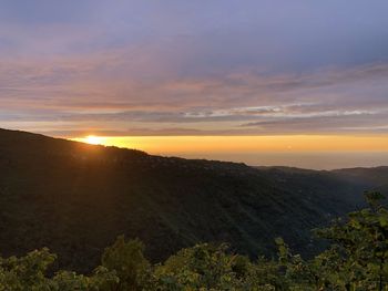 Scenic view of mountains against sky during sunset