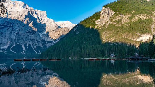 Scenic view of lake by mountains against sky