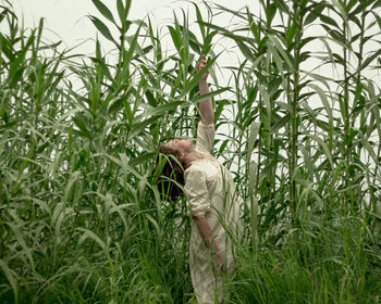 Side view of a man standing in field