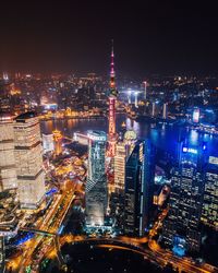 High angle view of city lit up at night