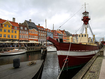 Boats moored at harbor