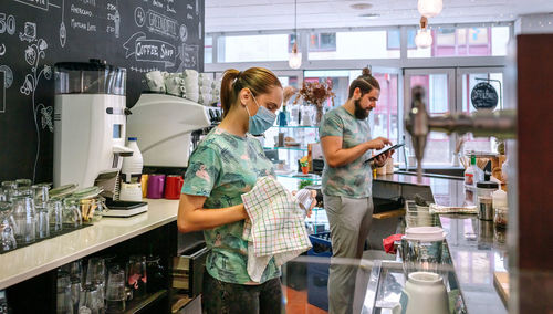 Waiter and waitress working at cafe