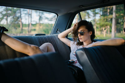 Young woman sitting in car