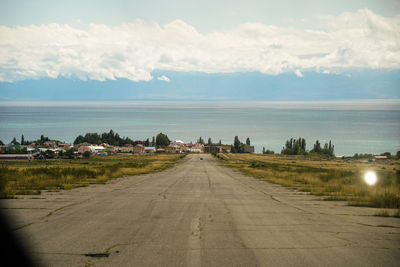 Road by city against sky