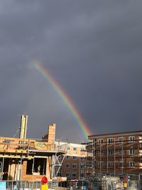 Low angle view of rainbow over city