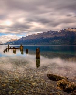 Scenic view of lake against cloudy sky