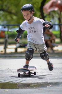 Full length of boy skateboarding on skateboard