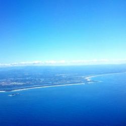 Scenic view of sea against blue sky