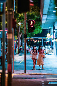 Woman walking on street in city