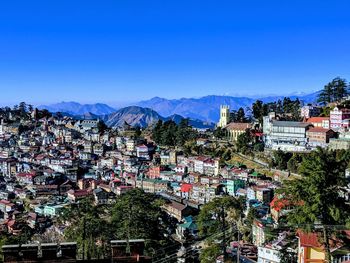 High angle view of townscape against blue sky