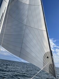 Low angle view of sailboat sailing on sea against sky