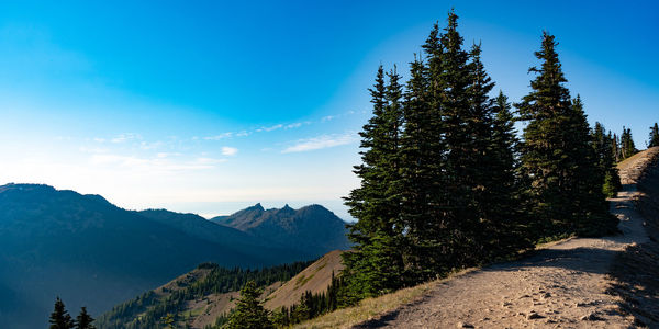 Scenic view of mountains against blue sky