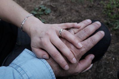 Close-up of wife holding husband hand