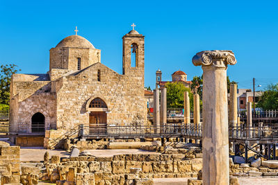 View of old historic church against clear blue sky