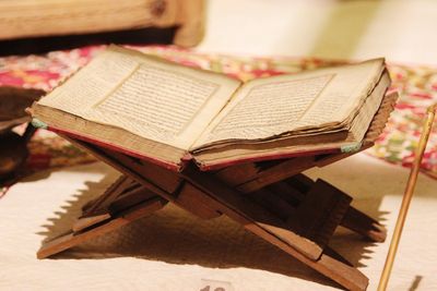 Close-up of open book on table at home