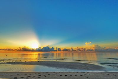 Scenic view of sea against sky at sunset