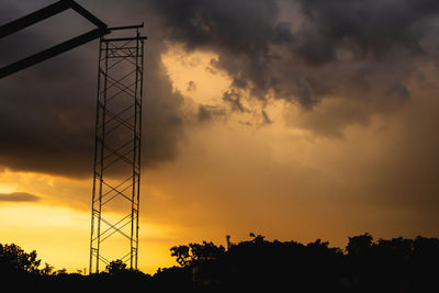 Low angle view of silhouette trees against sky during sunset