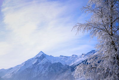 Scenic view of snowcapped mountains against sky