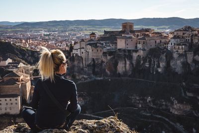 Rear view of woman looking at cityscape