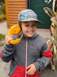 Smiling boy holding pumpkin