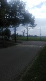 Empty road passing through field