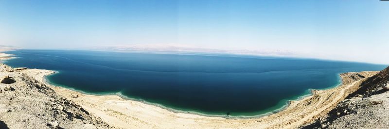 Panoramic view of sea and mountains against sky