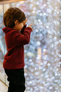 Side view of boy looking at lens flares