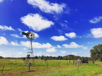 Windmill on field against sky