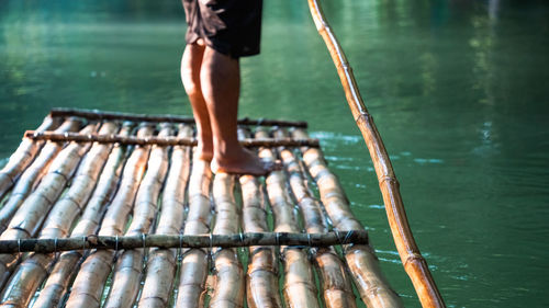 Low section of woman standing in lake