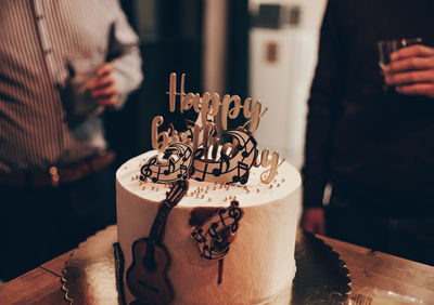 Close-up photo of birthday cake with music theme decorations