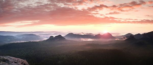 Scenic view of mountains against sky during sunset