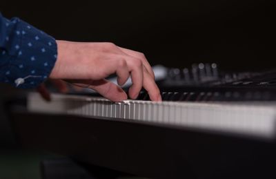 Close-up of hands playing piano
