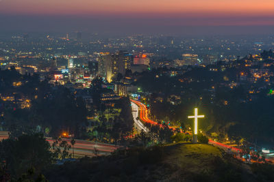 High angle view of illuminated buildings in city at night