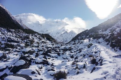 Scenic view of snow covered mountains against sky