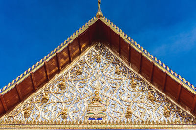 Low angle view of ornate building against blue sky