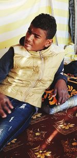 High angle view of boy relaxing on bed at home