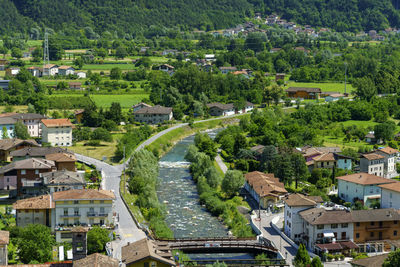 High angle view of townscape by river amidst buildings