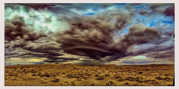 Scenic view of landscape against cloudy sky