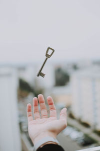 Cropped hand of person catching key