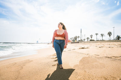 Young woman walking at beach