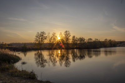 Scenic view of lake against sky during sunset