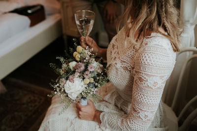 Midsection of woman holding flower bouquet